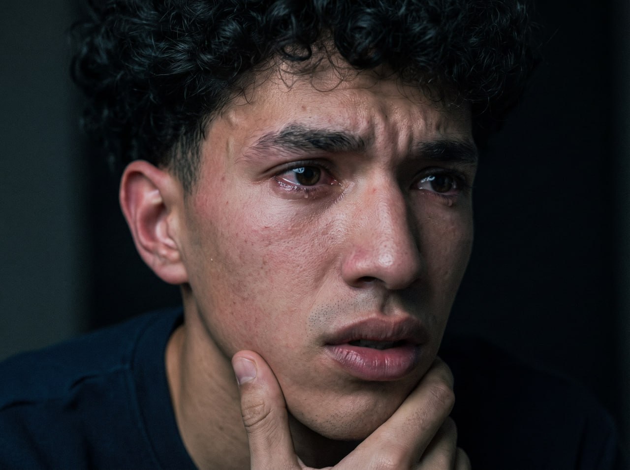 Intimate emotional close-up portrait of a young man